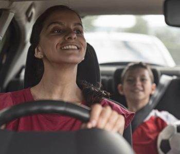 Driver smiling beside a car representing getting approved for a CarCoop Rent‑to‑Own on Centrelink or a Pension finance option in Australia.