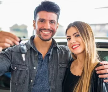 People standing beside a selection of cars available under a Rent‑to‑Own Cars for Temporary Visa Holders in Australia program, offering an alternative path to vehicle ownership.