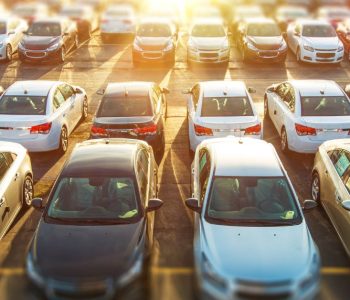 Rows of cars parked in a lot, representing vehicles available through a Rent‑to‑Own Car Option and flexible ownership programs.
