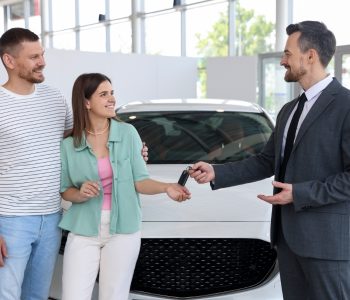 Credit score impact car finance applications in Queensland couple receiving car keys after loan approval