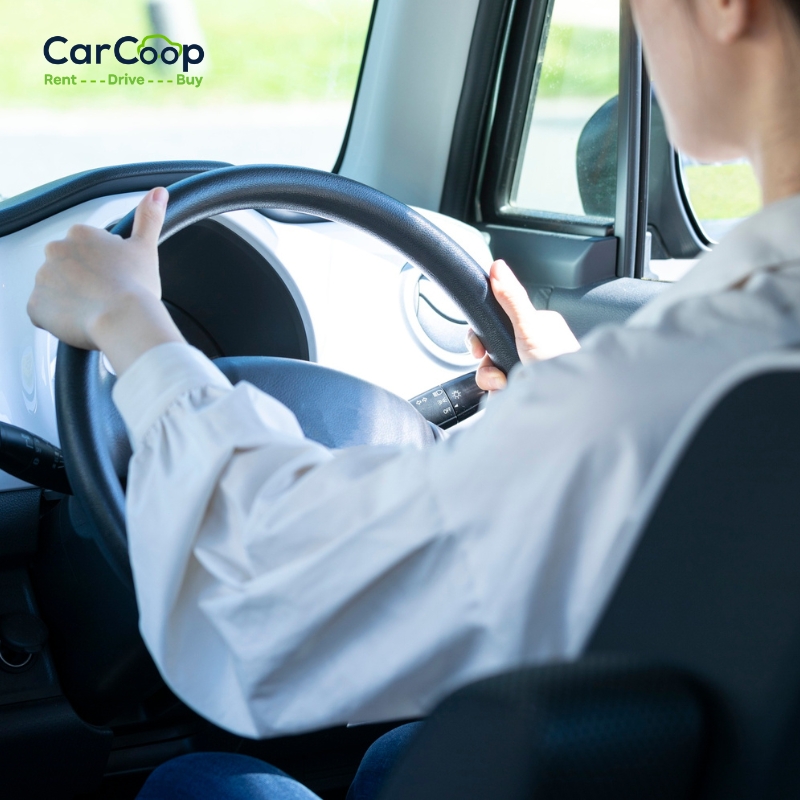 Driver holding the steering wheel inside a vehicle, representing Bad Credit Rent-to-Own Cars in Sydney with flexible driving solutions.