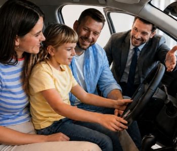 Family sitting inside a car with a CarCoop representative promoting EOFY car deals and savings of $20 per week on rent-to-own vehicles.